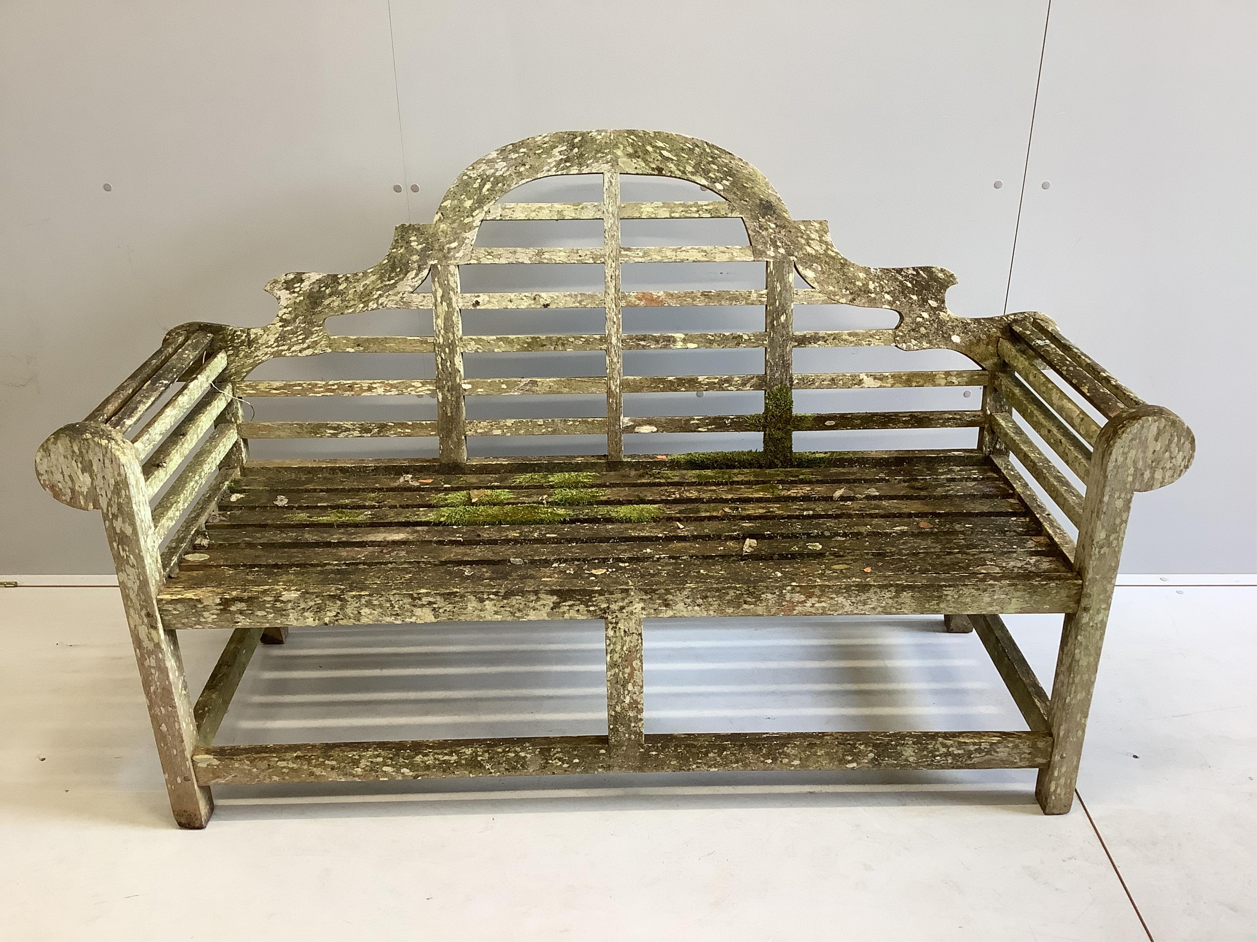A Lutyens style weathered teak garden bench, width 165cm, depth 57cm, height 102cm